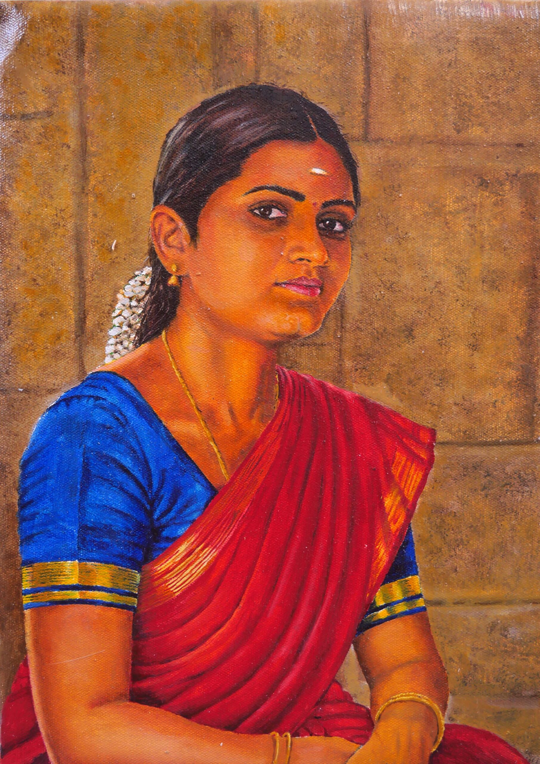 Traditional Tamil woman wearing a red saree and jasmine flowers